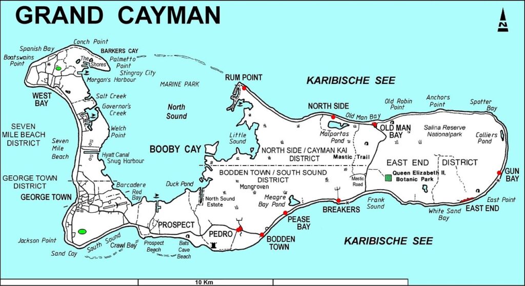 Map of Grand Cayman showing districts, towns, roads, and key locations labeled in English, surrounded by the Caribbean Sea.